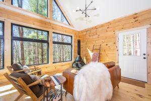 a living room with a large dog sitting on a couch at Camp Wondermore in Swanton