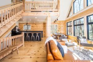 a living room with a couch and a bar at Camp Wondermore in Swanton