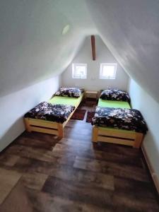 a room with two beds in a attic at Chata u Křupalů in Polevsko