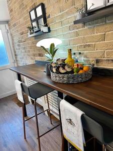 a table with a bowl of fruit on top of it at Peak District Self Catering Holiday Home in Glossop