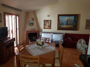 a living room with a table and a couch at Al comune in Atri