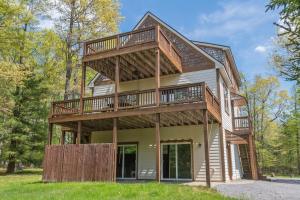 a house with a wrap around porch with a wrap around deck at Carmel Sunday in Swanton