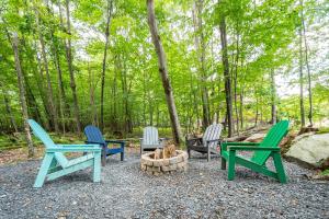 three chairs and a fire pit in the woods at No Black Tie Affair in McHenry