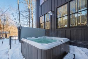 a hot tub in the snow next to a building at No Black Tie Affair in McHenry
