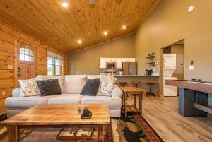 a living room with a couch and a kitchen at Base Camp in McHenry