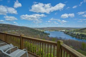 a deck with two chairs and a view of a river at Vista Emmanuel in McHenry