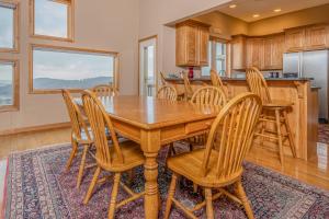 a kitchen and dining room with a wooden table and chairs at Vista Emmanuel in McHenry +85 photos