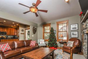 a living room with a couch and a christmas tree at Winding Down Slope Side in Oakland