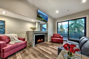 a living room with a fireplace and red furniture at LUXE 15 Blue Diamond Lodge Lake Tahoe Hot Tub in Stateline