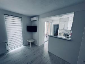 an empty room with a kitchen and a living room at Stan 7 in Kiseljak