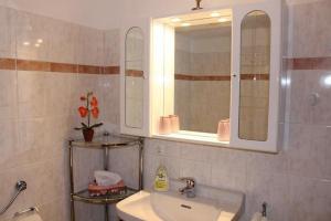 a bathroom with a sink and a mirror at Haus Watzmannblick in Bischofswiesen +11 photos