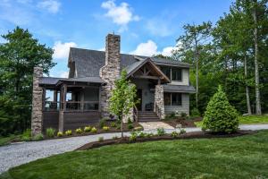 a home with a stone house with a chimney at Above it All in McHenry