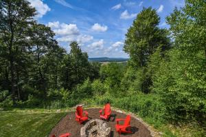 a group of red chairs sitting on a hill at Above it All in McHenry