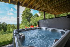 a hot tub on the back of a patio at Above it All in McHenry