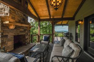 a screened in porch with a couch and a fireplace at Above it All in McHenry +87 photos
