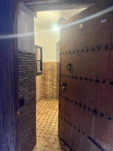 an open door to a bathroom with a brick wall at Riad Ago in Marrakech