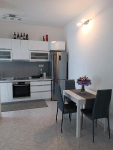 a kitchen with a table and chairs and a refrigerator at Home away from home - Inalpi Arena, ex Pala Alpitour apartment in Turin