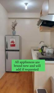 a kitchen with a refridgerator and a refrigerator at Seawind 2 bedroom comfort in Davao City