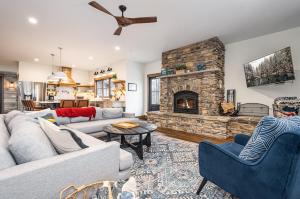 a living room with a couch and a stone fireplace at Dreidels Den in McHenry