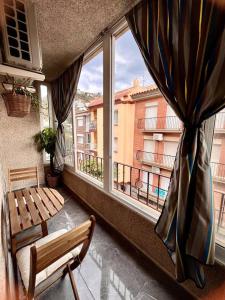 a balcony with a bench and a window at Amplio apartamento tranquilo cerca de la playa in Roses