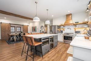 a large kitchen with wooden floors and white cabinets at Dreidels Den in McHenry