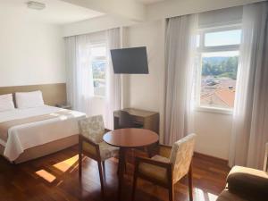 Cama ou camas em um quarto em Grande Hotel Amparo
