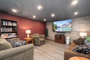 a living room with couches and a flat screen tv at Slope Side in McHenry