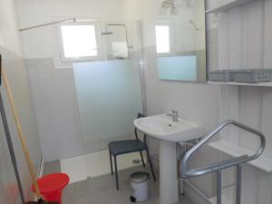 a bathroom with a sink and a mirror and a stool at LES BRUYERES in Léon