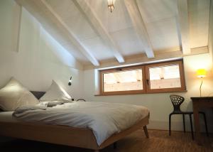 a bedroom with a large bed with a window at Holzer 2.0 in Brannenburg