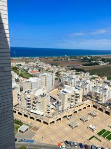 an aerial view of a city with buildings and the ocean at A modern apartment in Acre in ‘Akko