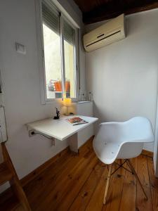 a white desk and chair in a room with a window at Latina in Madrid