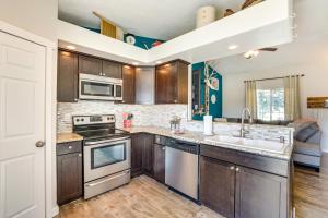 a kitchen with a sink and a stove top oven at Charming Nampa Home with Backyard and Grill! in Nampa