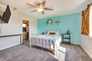 a bedroom with a bed with a blue wall at Charming Nampa Home with Backyard and Grill! in Nampa
