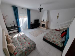 En eller flere senge i et værelse på Casa Sol e Mar