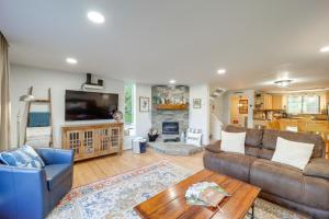 a living room with a couch and a table at Cozy Sugar Mtn Condo with AandC - Walk to Ski and Golf! in Sugar Mountain