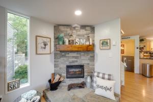 a living room with a stone fireplace at Cozy Sugar Mtn Condo with AandC - Walk to Ski and Golf! in Sugar Mountain