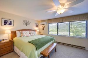 a bedroom with a bed with a ceiling fan and a window at Cozy Sugar Mtn Condo with AandC - Walk to Ski and Golf! in Sugar Mountain