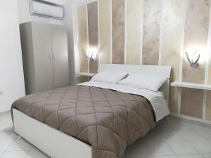 a bedroom with a bed with two lights on the wall at B&B Pompeii Luxury in Pompei