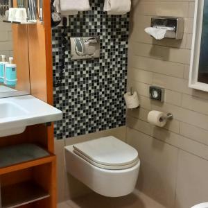 a bathroom with a toilet and a sink at Novotel Roma Eur in Rome