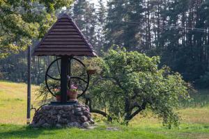 a small monument in the middle of a field at Agroturystyka Leśna Dolina 