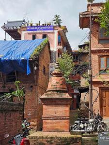 a brick building with a blue tarp on top of a building at Annapurna Guest House in Bhaktapur