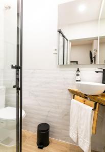 a white bathroom with a sink and a toilet at Lisboa 85 Suites & Apartments by RIDAN Hotels in Lisbon