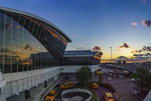 a large building with cars parked in a parking lot at SWJ 3rd - Sleeps 7,Close to LGA,Times Sq in 25 min in New York