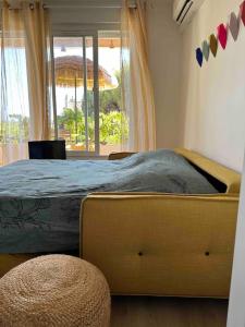 a bedroom with a large bed with a window at Le repaire de la Vierge bohème vue mer in Cassis