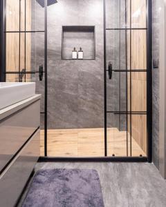 a shower with a glass door in a bathroom at Luxury apartment in the heart of Nisantasi in Istanbul