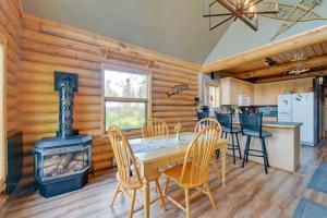 a dining room and kitchen with a wood stove at Soldotna Fishing Lodges with Dock on Kenai River! in Sterling