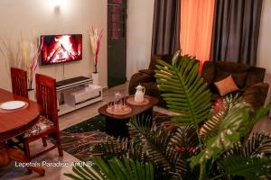 a living room with a couch and a tv at Lapetals-Paradise-3bedrooms-ABNB machakos town in Machakos