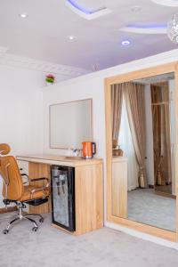 a room with a desk and a chair and a mirror at MONDEESTARS LUXURY HOME in Ibadan