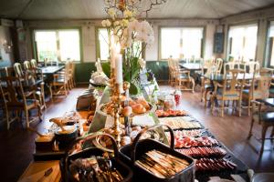 a long table with food on it in a restaurant at Åkerblads Hotell Gästgiveri Spa in Tällberg