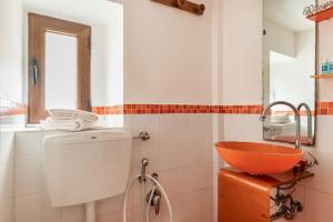 a bathroom with a sink and a bowl on a counter at Monolocale "Duomo" in Messina +2 photos